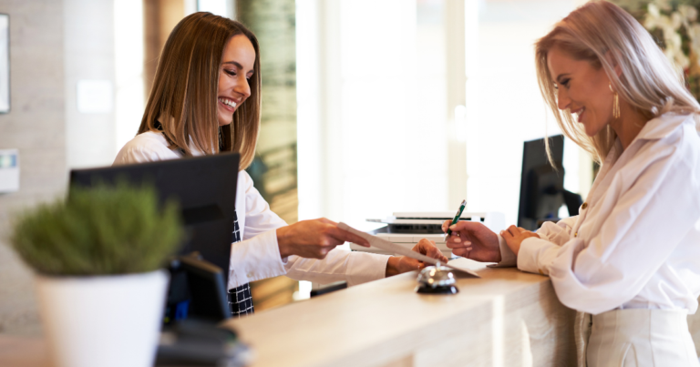 dental receptionist welcoming a patient to the office